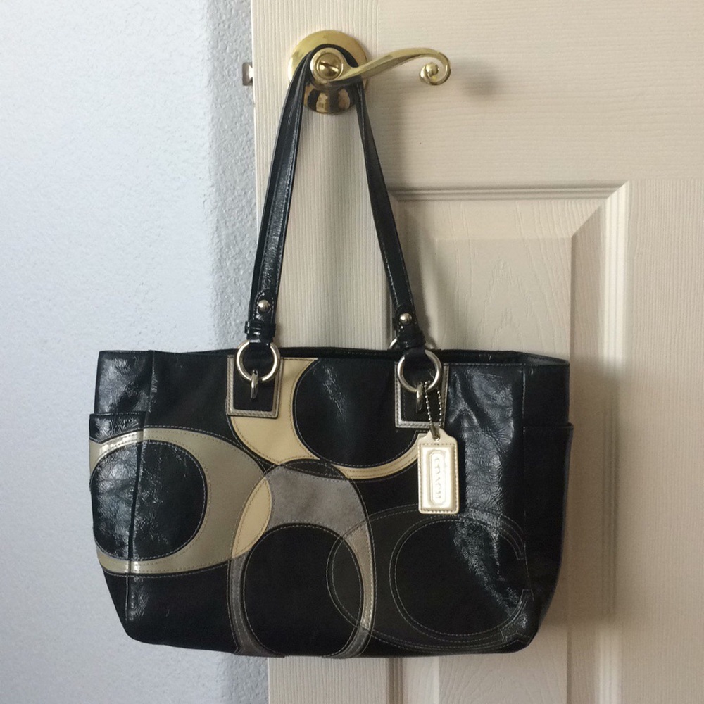 Black Coach purse with tan and grey lettering